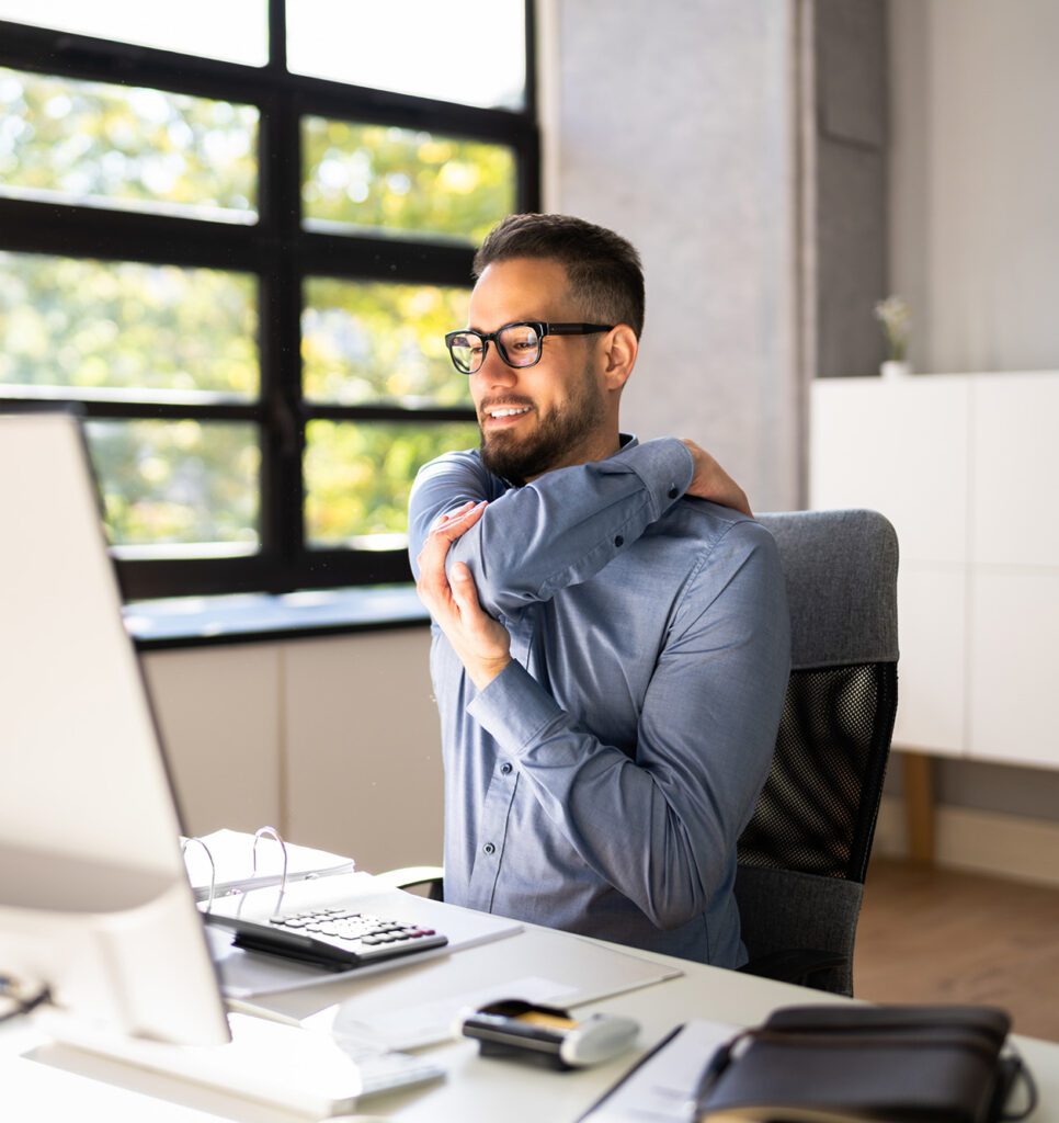 Shoulder Pain And Posture. Man Suffering Shoulder Pain And Posture. Man Suffering Near Workstation Computer
